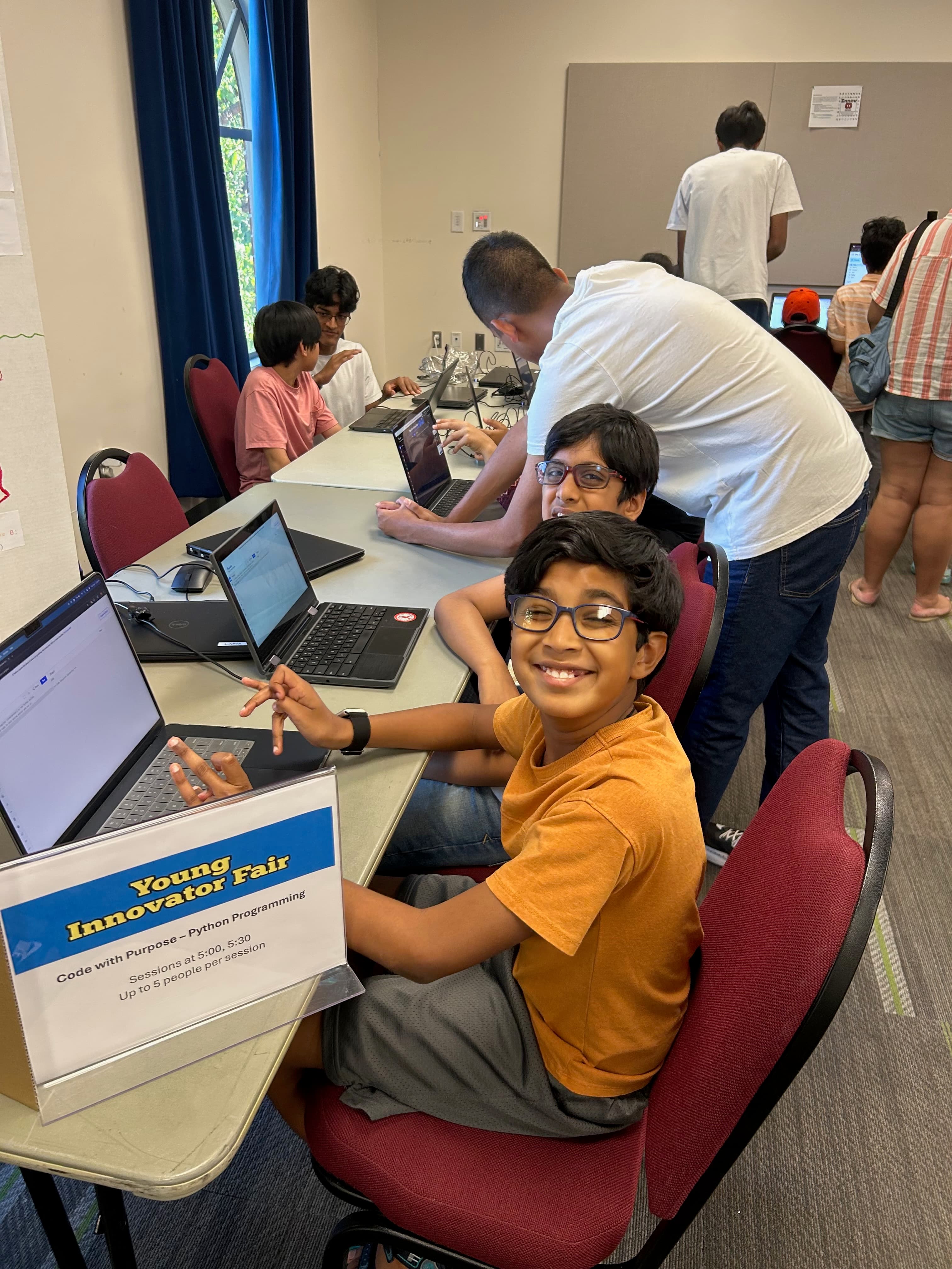 Student smiling while learning to code at CodeWithPurpose